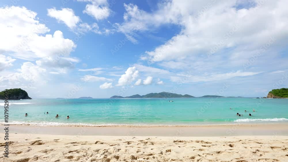 swimmers frolic, wade, play and float in the emerald waters of smugglers cove on Tortola in the Caribbean swimmers frolic, wade, play and float in the emerald waters of smugglers cove on Tortola in the Caribbean