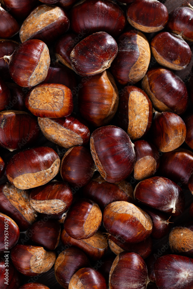 Closeup of shelled edible chestnuts in large quantities as natural nut background Closeup of shelled edible chestnuts in large quantities as natural nut background