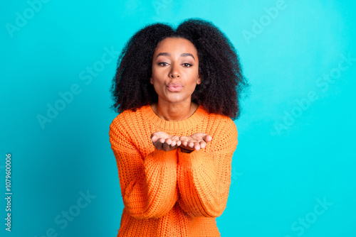 Photo portrait of pretty young girl semd you air kiss wear trendy knitwear orange outfit isolated on aquamarine color background photo