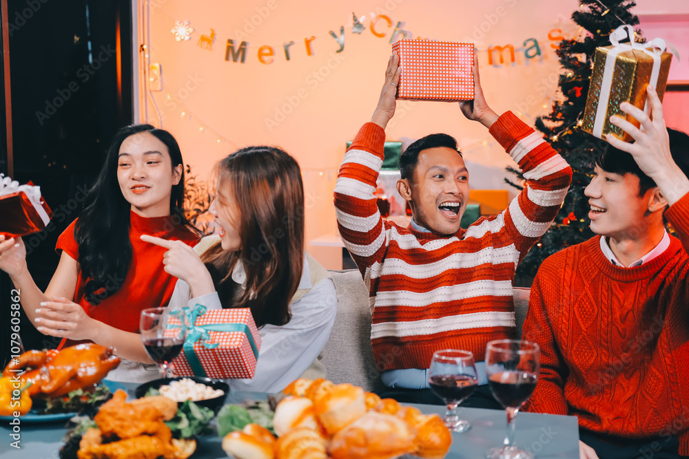 Friends opening Christmas gifts in living room