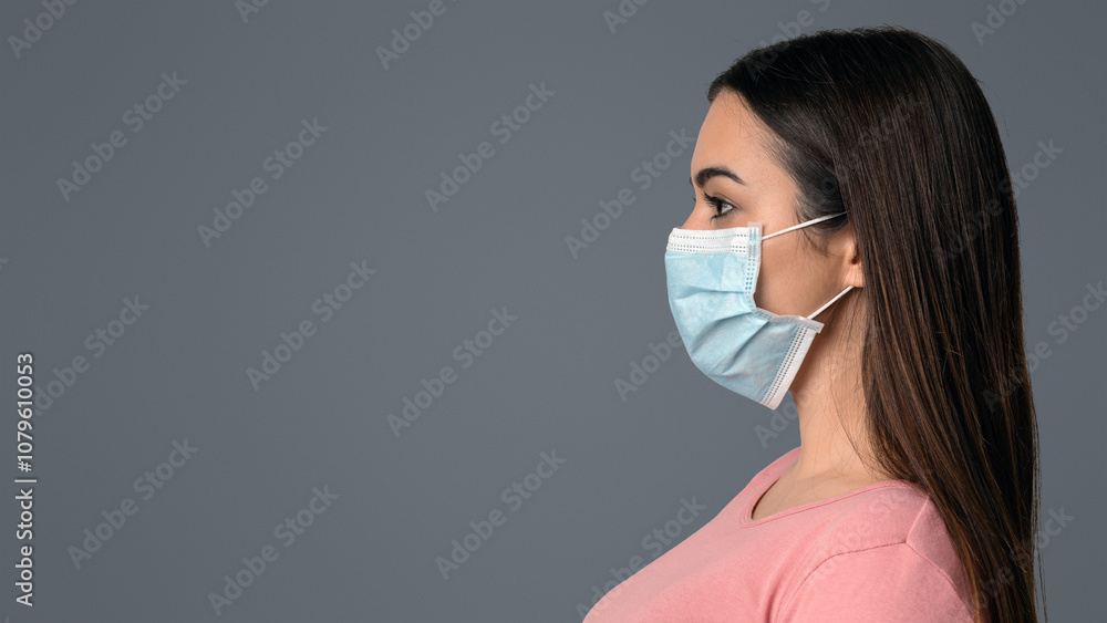 Coronavirus Concept. Side View Portrait Of Woman In Protective Medical Face Mask Standing Over Light Studio Background With Free Space Coronavirus Concept. Side View Portrait Of Woman In Protective Medical Face Mask Standing Over Light Studio Background With Free Space