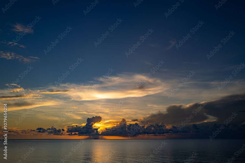 Sunset sea landscape. Colorful beach sunrise with calm waves. Sunrise over the sea and beautiful clouds. Nature sea sky. Sunrise with clouds of different colors against the blue sky and sea. Sunset sea landscape. Colorful beach sunrise with calm waves. Sunrise over the sea and beautiful clouds. Nature sea sky. Sunrise with clouds of different colors against the blue sky and sea.