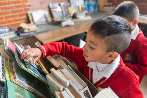 Two little kids in the library with books