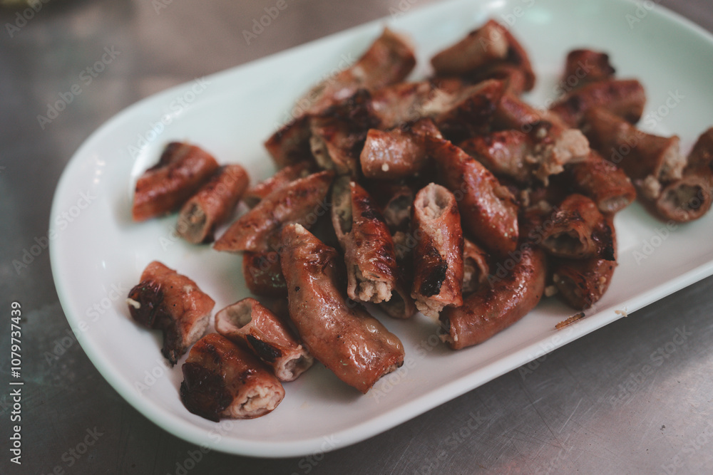 Grilled pork intestines. Roasted pork Chitterlings. In Thai called Sai On Yang. Traditional and local Thai food. Thai north-eastern people. Street food, Beer appetizer Grilled pork intestines. Roasted pork Chitterlings. In Thai called Sai On Yang. Traditional and local Thai food. Thai north-eastern people. Street food, Beer appetizer