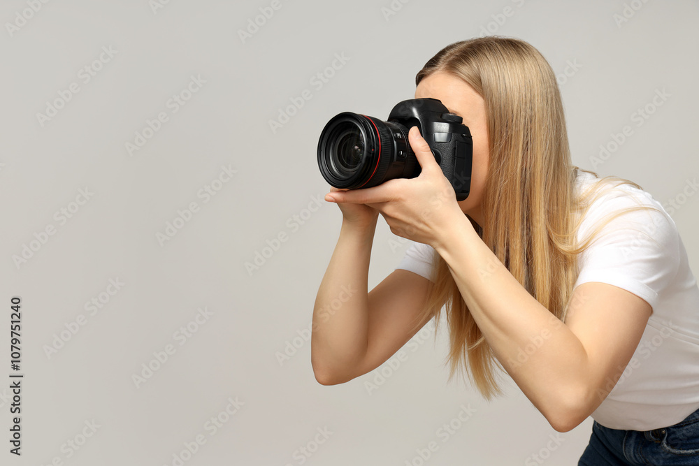 Cheerful girl photographer, on a gray background. Cheerful girl photographer, on a gray background.
