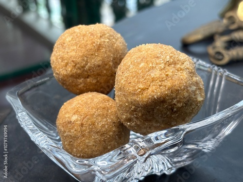 Exclusive shots of rare kerala traditional desert known as ari unda or rice laddu photo