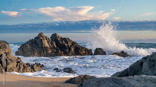 Dramatic Coastal Scene with Crashing Waves and Rocky Shoreline at Sunset
