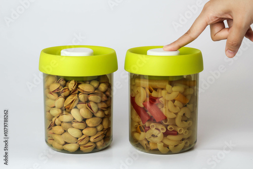 women pressing on Vacuumized Airtight Clear High Borosilicate Glass Jar pistachio Large Glass Storage Jar photo