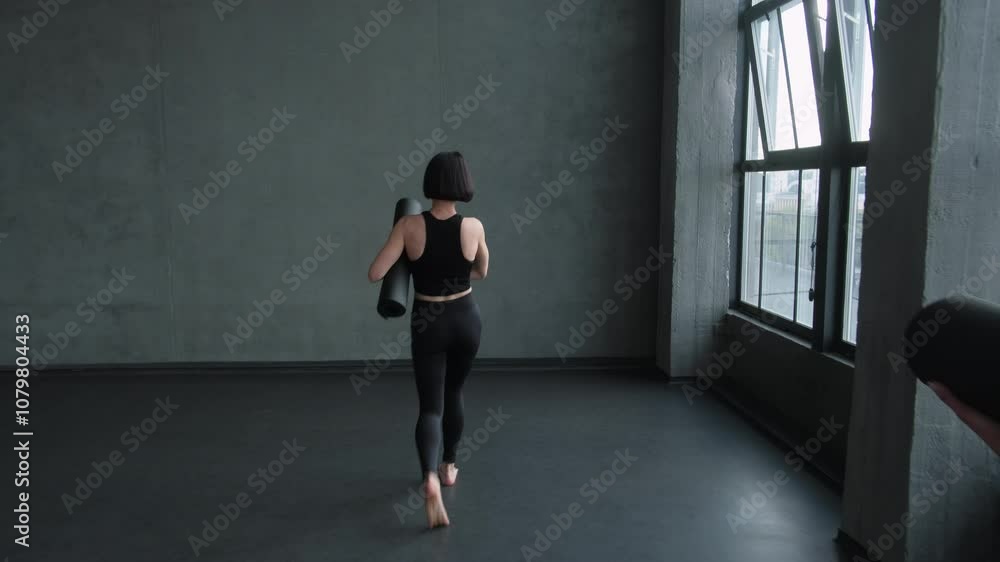 Yoga group. Fitness recreation. Athletic female pilates instructor in activewear leading people with mat training workout start in gym studio indoors. Yoga group. Fitness recreation. Athletic female pilates instructor in activewear leading people with mat training workout start in gym studio indoors.