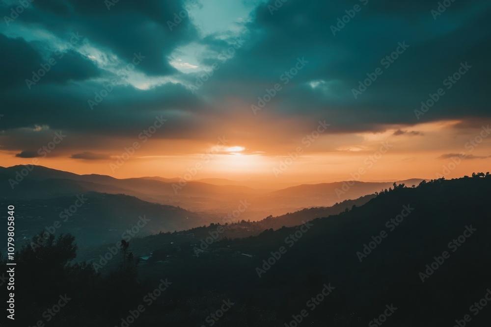 A dramatic sunset over a mountain range, with clouds and a warm orange glow. A dramatic sunset over a mountain range, with clouds and a warm orange glow.