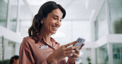 Happy woman, doctor or typing with phone for communication, good news or telehealth at hospital. Female person, medical employee or smile with mobile smartphone for online donation to clinic research photo