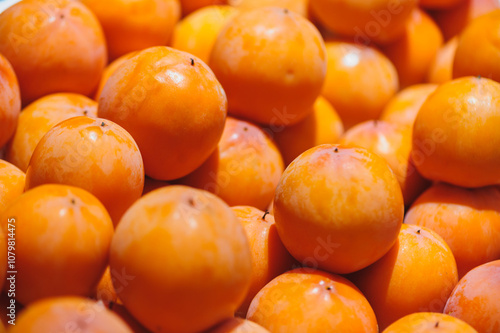 Fresh persimmon fruits selling at market