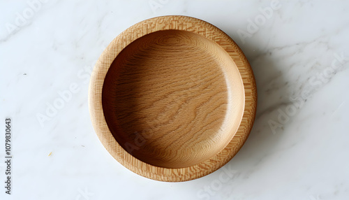 An empty, oval-shaped wooden bowl with a light wood grain.