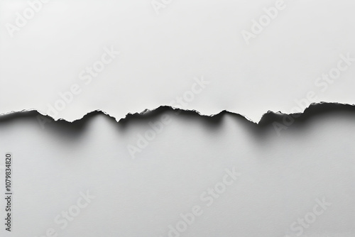 Torn paper edge revealing white background.