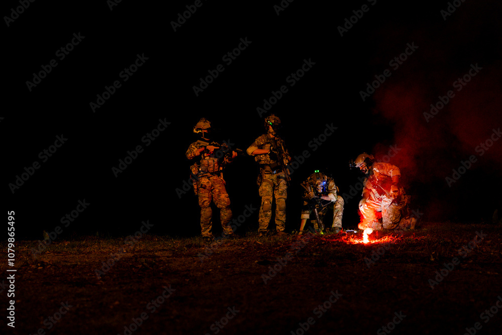 Fototapeta premium A group of military men in combat gear patrol in the middle of a desert and tropical jungle. Soldiers in full combat gear in dry weather conditions assemble and march on a mission.