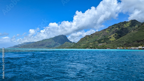 Idyllic scenic view of the tropical island of Mo'orea in French Polynesia, South Pacific with blue turquoise ocean water and rugged mountainous terrain of island