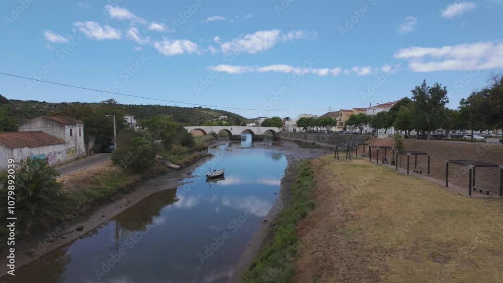 Tilt up shot of Roman Bridge over Arade River, peaceful landscape from Silves, Algarve Tilt up shot of Roman Bridge over Arade River, peaceful landscape from Silves, Algarve