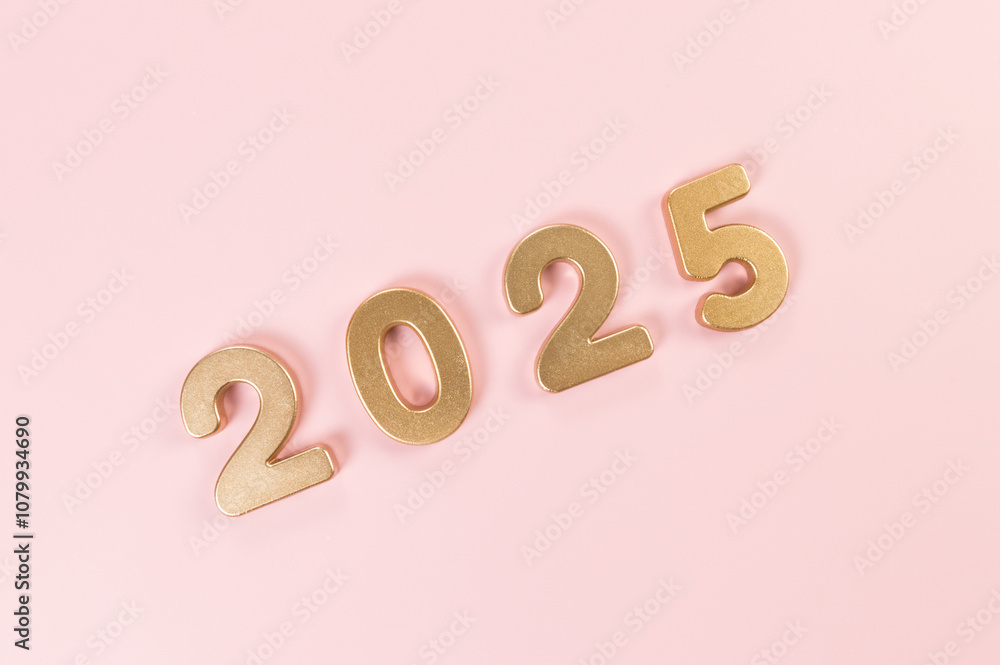 2025 Happy New Year. Top view of gold numbers on pink background. Copy space, flat lay. 2025 Happy New Year. Top view of gold numbers on pink background. Copy space, flat lay.