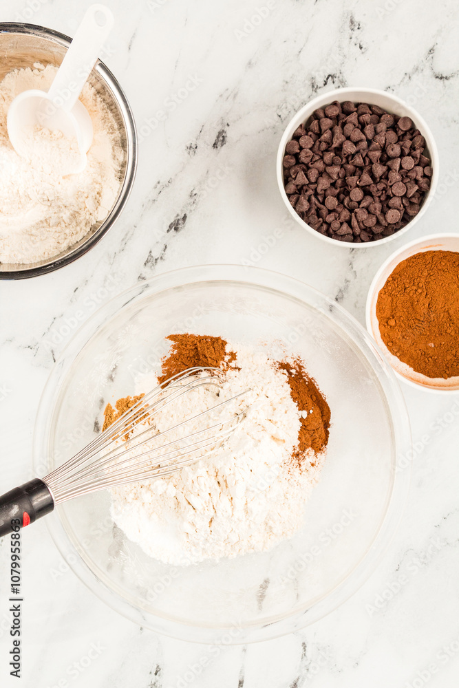 Flour, cinnamon, and chocolate chips set for baking pumpkin muffins Flour, cinnamon, and chocolate chips set for baking pumpkin muffins