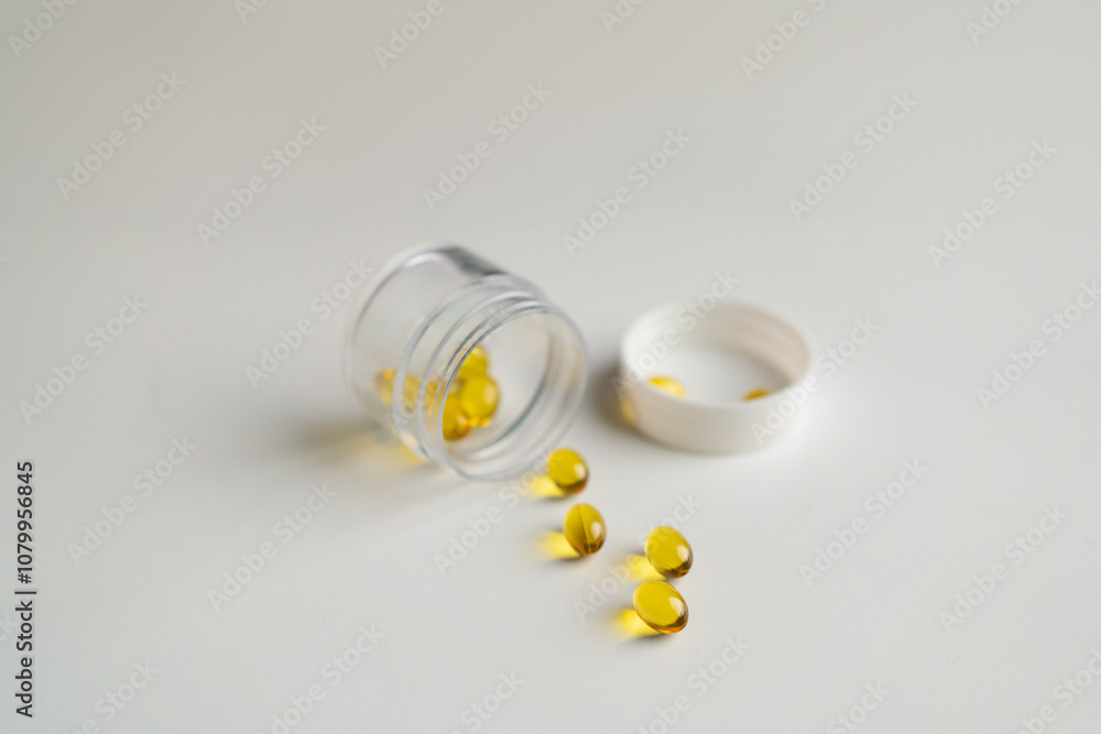 Open pill bottle with capsules on white background Open pill bottle with capsules on white background