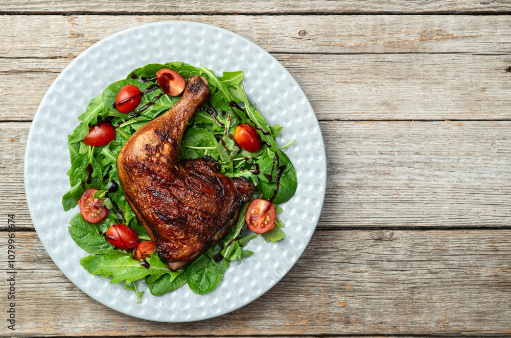 Grilled chicken legs with tomatoes and salad . Top view Grilled chicken legs with tomatoes and salad . Top view