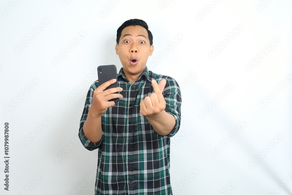 surprised asian man holding smartphone and give love shape isolated on white background surprised asian man holding smartphone and give love shape isolated on white background