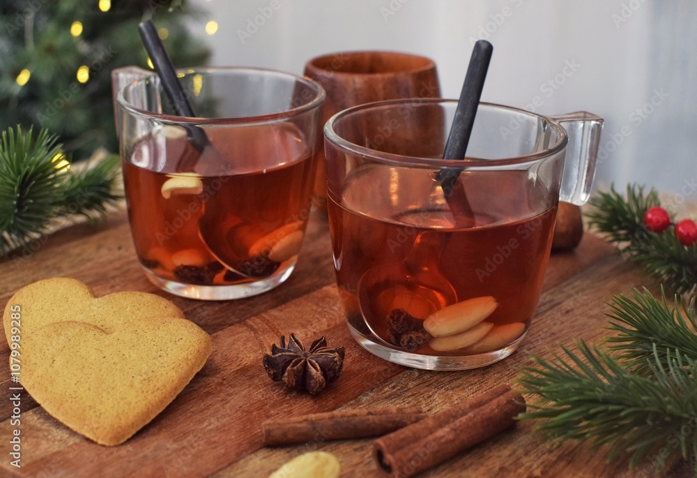Traditional Swedish mulled wine with nuts and raisins in glass mugs. Traditional Swedish mulled wine with nuts and raisins in glass mugs.