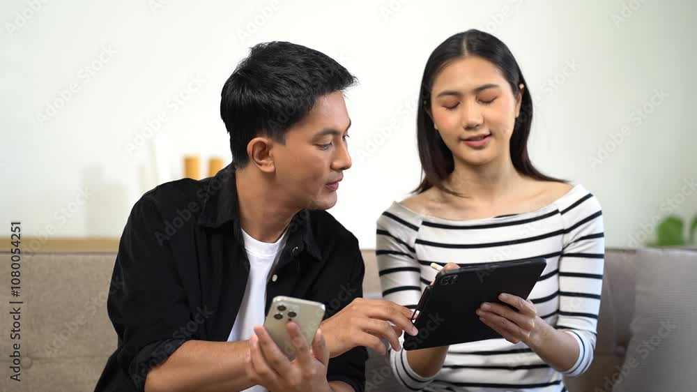 Successful young couple is moving to a nice new place, around boxes with their belongings. The room is very bright and bright, they are wearing casual clothes. Successful young couple is moving to a nice new place, around boxes with their belongings. The room is very bright and bright, they are wearing casual clothes.