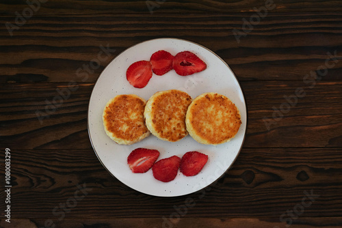Wallpaper Mural Plate with Syrniki and Strawberries on Wooden Background Torontodigital.ca