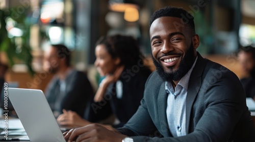 Smiling Black Man Working on Laptop in Cafe