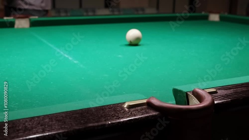 Wallpaper Mural Playing Russian billiards on a green table. The professional player hits the white ball successfully rolling its into the middle pocket. Good goal. Successful attempt. A great game. Hobby pastime. 4K Torontodigital.ca