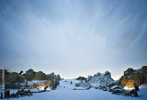 A snowy landscape with a large mountain in the background