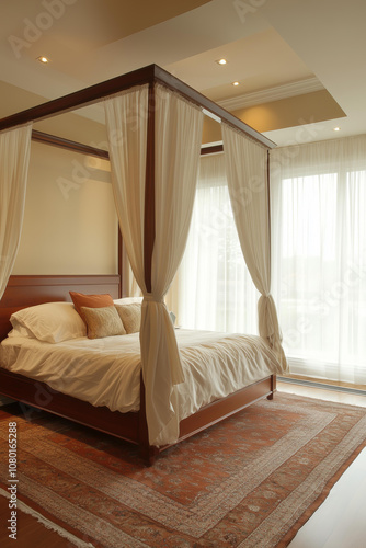 four-poster bed with white linen and sheer curtains in the bedroom of an Indian-style villa, featuring natural wood tones and beige rug flooring.