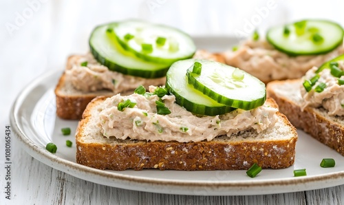  sandwiches topped with a creamy smoked mackerel spread, garnished with fresh cucumber slices and sprinkled with chopped chives, Generative AI 