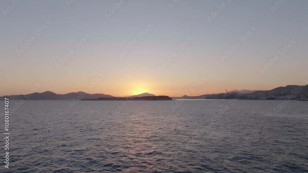 Sunset over the sea in Piraeus, Athens, Greece Sunset over the sea in Piraeus, Athens, Greece