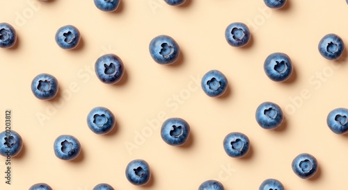 A flat lay of fresh blueberries on a light background, showcasing their vibrant color and texture.