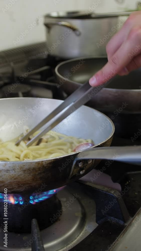 Cooking Spaghetti Pasta Food With Clams Fish In The Pan Of A Restaurant
