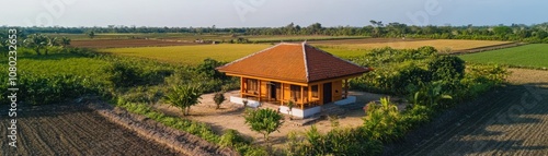 A serene wooden house surrounded by lush fields and greenery.