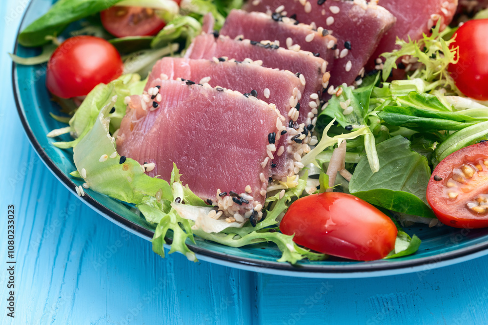 Salad with raw tuna , sesame and cherry tomatoes photography . Top view Salad with raw tuna , sesame and cherry tomatoes photography . Top view