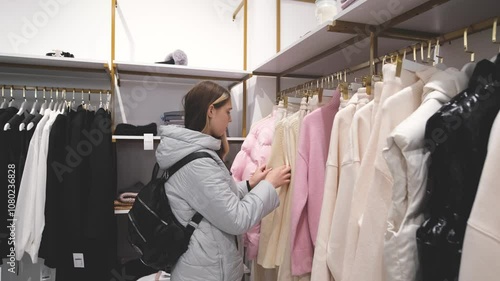Wallpaper Mural Teenage girl choosing clothes near a rack with hangers in a store Torontodigital.ca