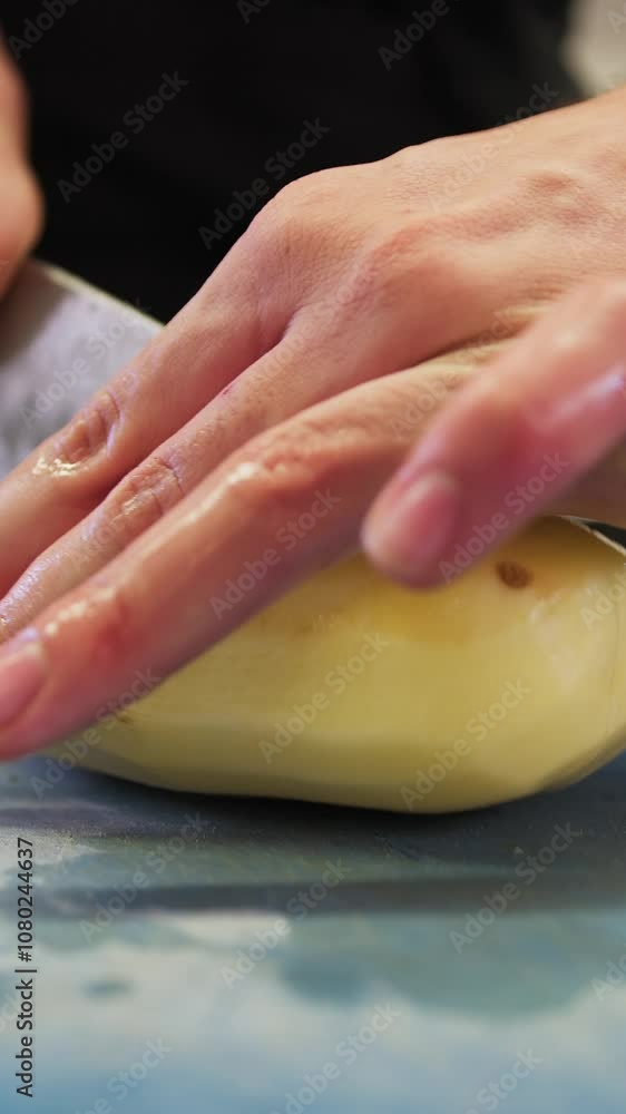 Chef Helper is Cutting Potatoes for Baking in Italian Restaurant Kitchen Chef Helper is Cutting Potatoes for Baking in Italian Restaurant Kitchen