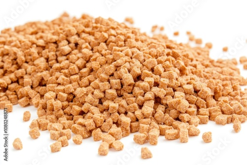 A pile of brown sugar cubes on a white surface