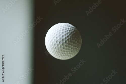 A white golf ball soaring through the air, great for sports or outdoor scenes