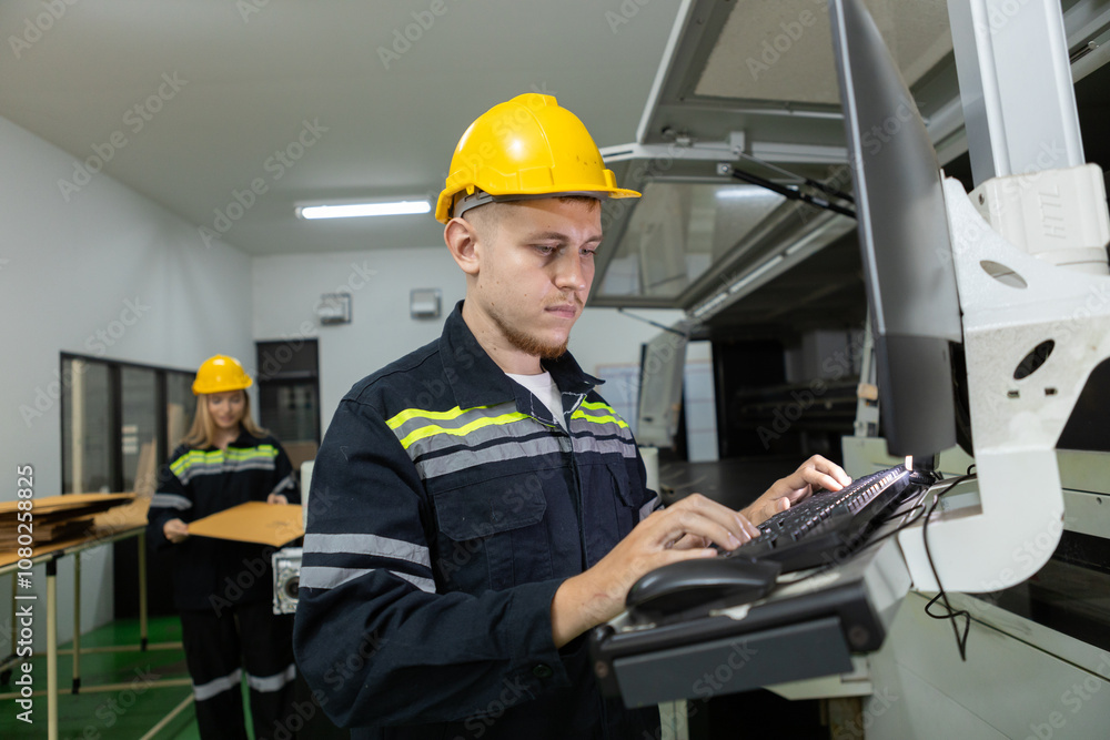 Man paper warehouse worker check quality and quantity cardboard corrugated carton in storage stock product with computer system . Large industry in paper production line.