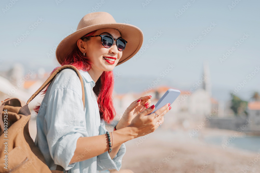 Fototapeta premium Tourist using smartphone while visiting european city on sunny summer day