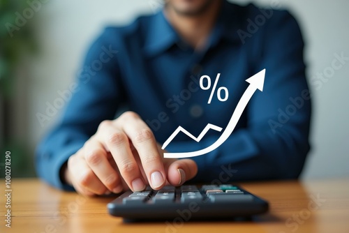 Man Using Calculator with Financial Growth Symbol, Perfect for Business, Investment, and Finance Concepts, Blue Shirt Dominant Color, Confidence and Success Feelings photo