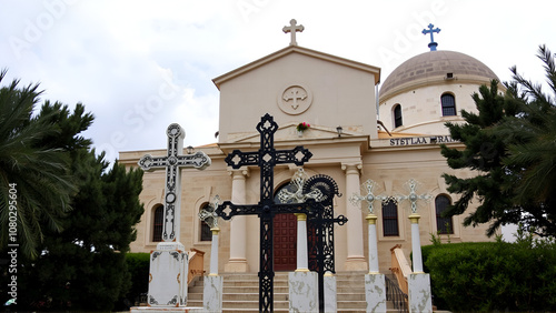 Monuments with a metal crosses in front of the facade of the Stella Maris Monastery which is located on Mount Carmel in Haifa city in northern Israel photo