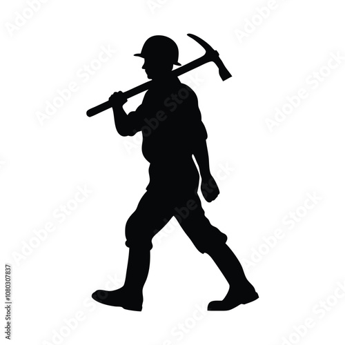 A man is holding a pickaxe and walking on a rock. He is wearing a helmet