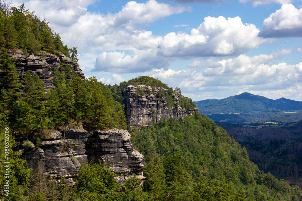large multi-layered rocks on the background of green trees large multi-layered rocks on the background of green trees