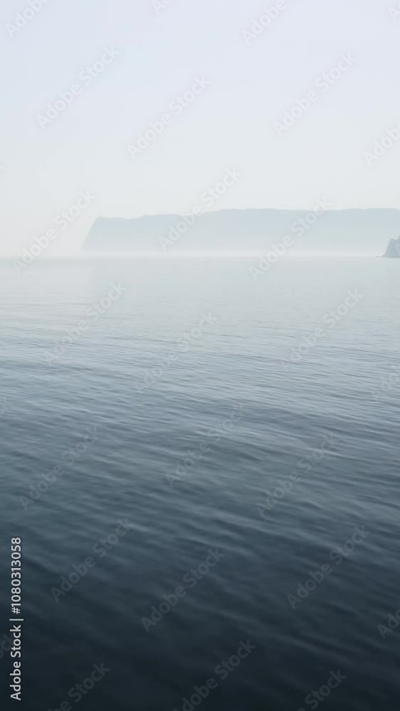 Vertical aerial view on sea water surface, camera flies over clear sea water. Sun glare. Abstract nautical summer ocean nature. Holiday, vacation and travel concept. Nobody. Weather and climate change Vertical aerial view on sea water surface, camera flies over clear sea water. Sun glare. Abstract nautical summer ocean nature. Holiday, vacation and travel concept. Nobody. Weather and climate change